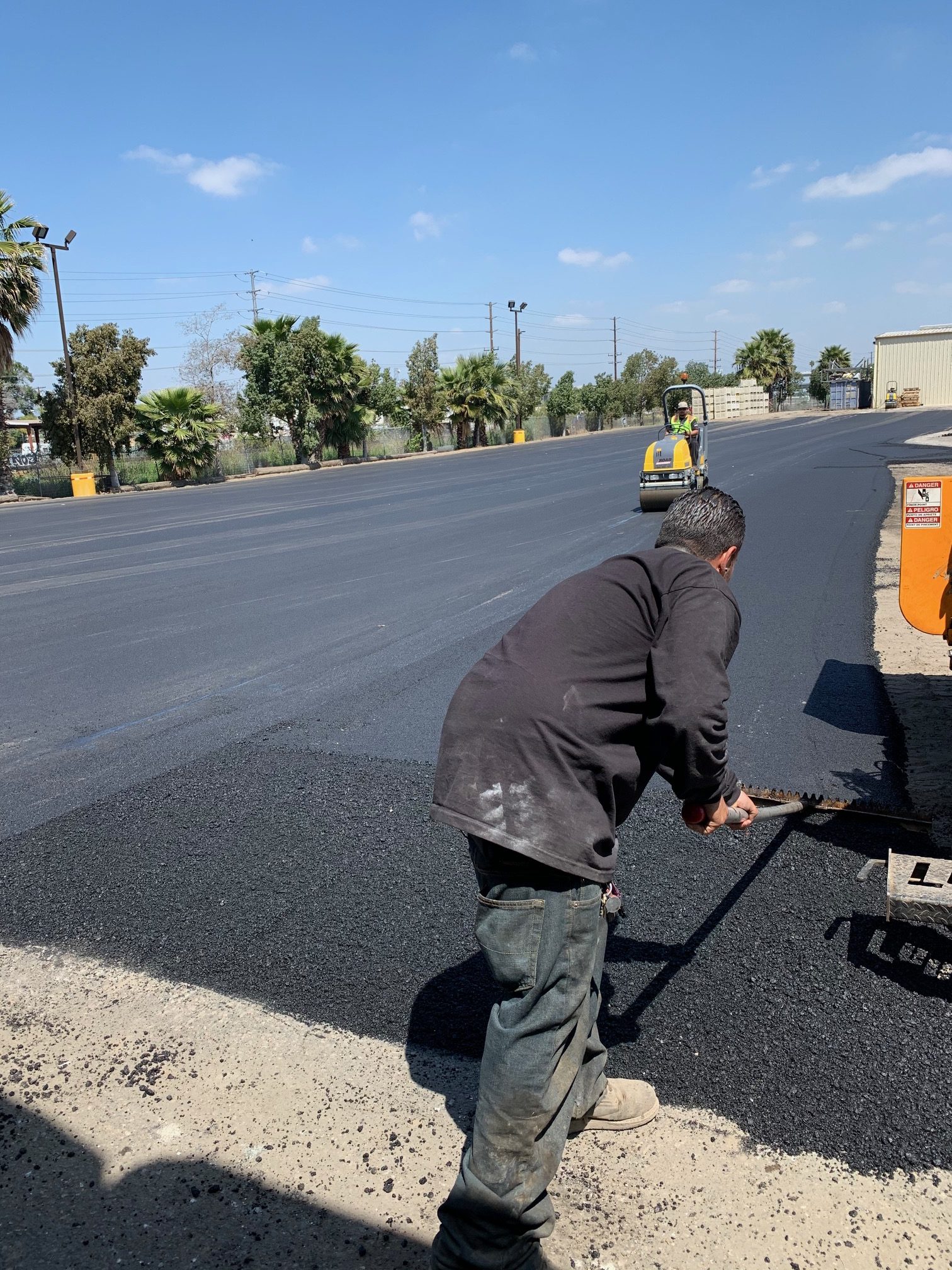 Freshly laid blacktop asphalt paving and hot tarring for a smooth residential surface by Black Diamond Asphalt.